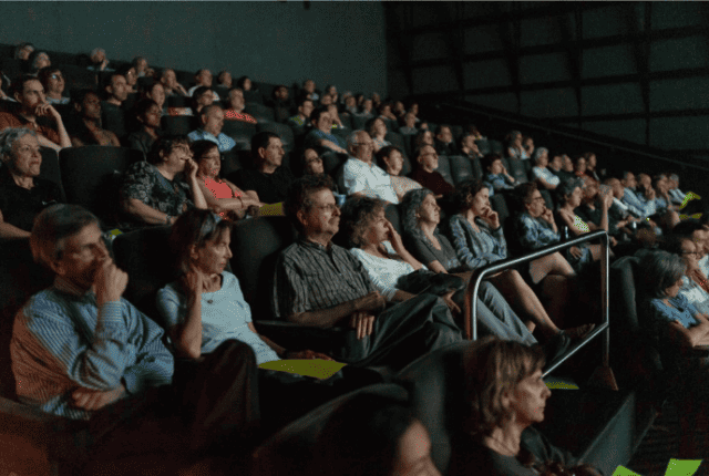 video being shown on screen in theater.