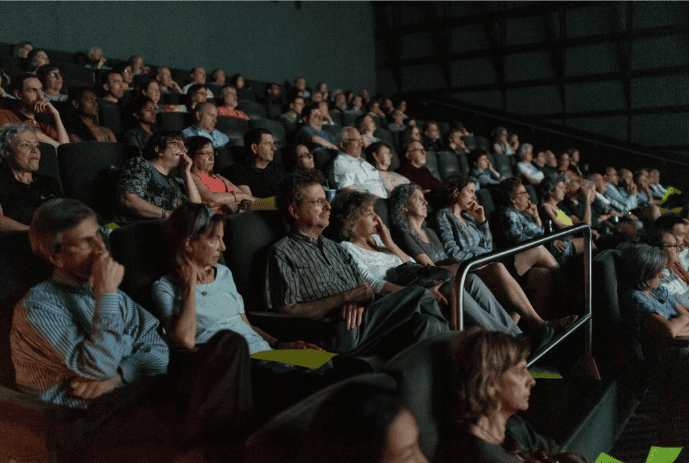 video being shown on screen in theater.