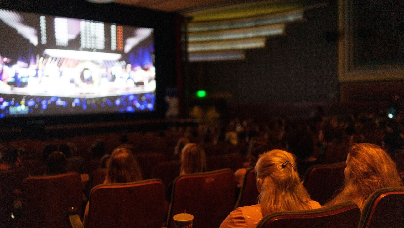 video being shown on screen in theater.