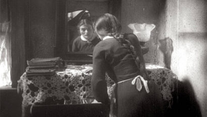 Film Still from I Have Sinned (Al Khet). Esther standing at mirror.