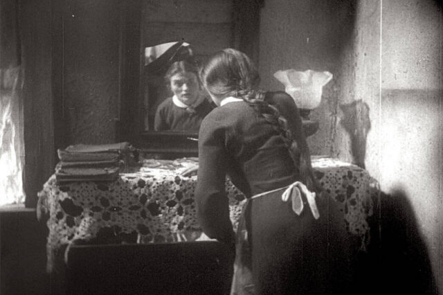 Film Still from I Have Sinned (Al Khet). Esther standing at mirror.