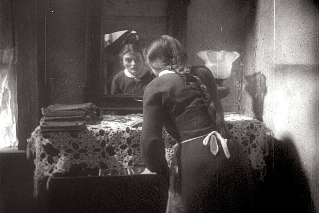 Film Still from I Have Sinned (Al Khet). Esther standing at mirror.