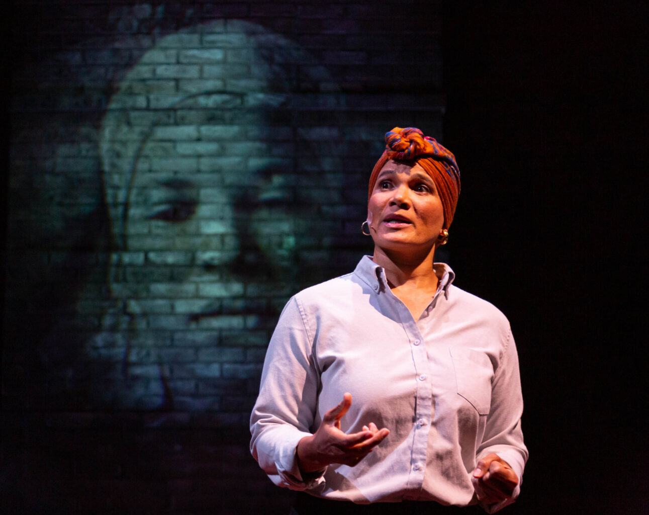 woman delivering monologue in performance on stage.