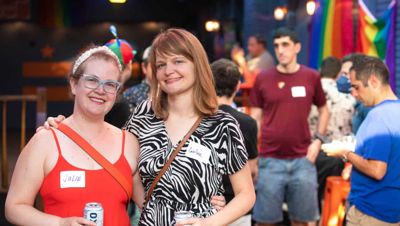 two women smiling at a gloe event.