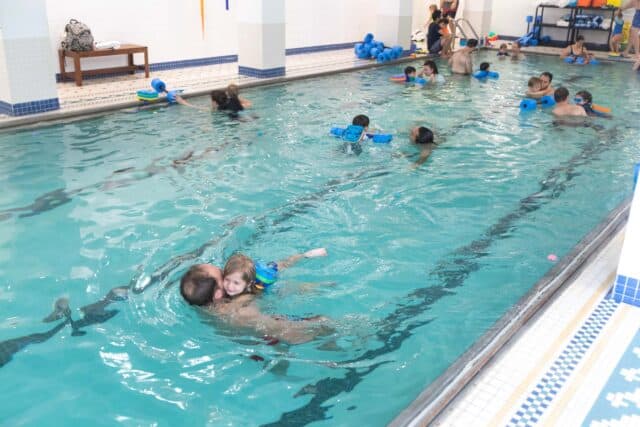 people swimming in and indoor pool.