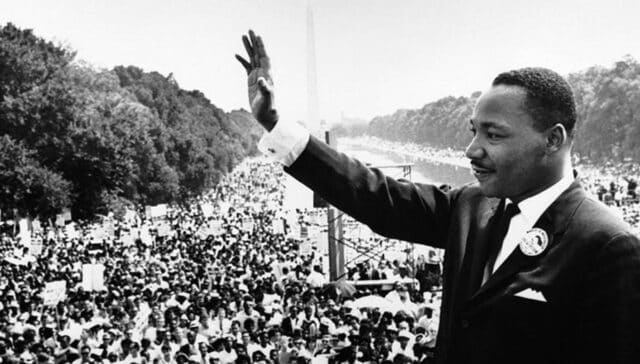 Dr. Martin Luther King waving to audience at historic march on Washington event, 1963