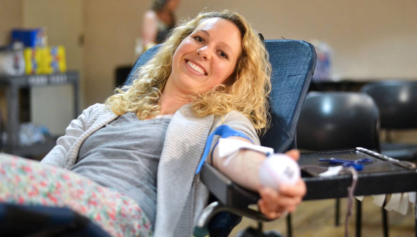 Woman reclining in chair donating blood