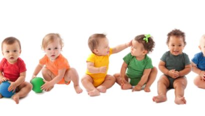 Babies in rainbow colored outfits