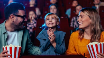 Family watching movie in theater