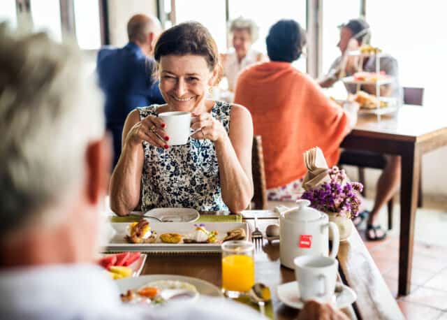 Older adult enjoying brunch at table