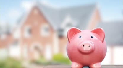 Image of piggy bank with house in background, estate planning