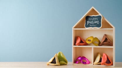 Image of toy dollhouse with Hamantaschen purim cookies inside