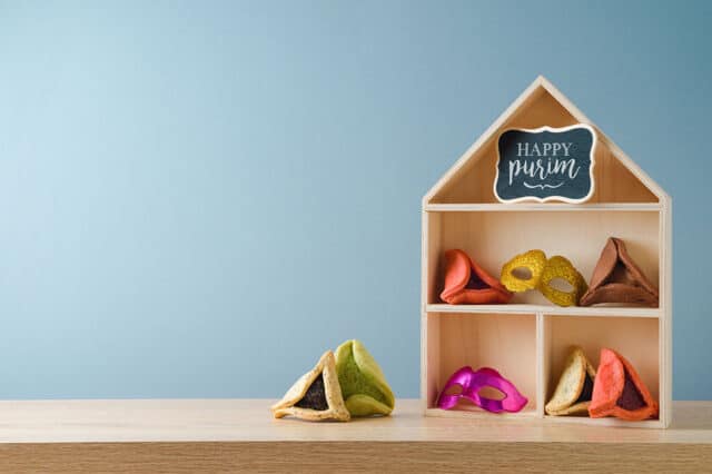 Image of toy dollhouse with Hamantaschen purim cookies inside